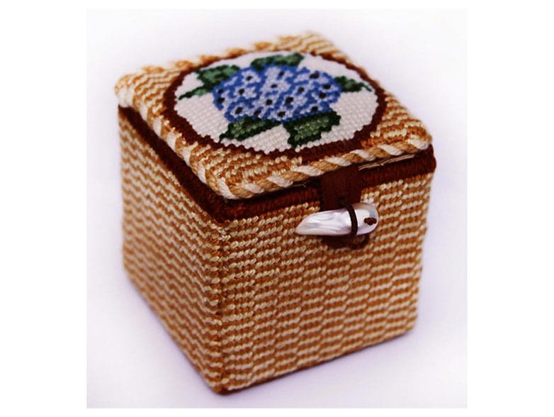 A small woven box with a flower design, exhibited at CBK Needlepoint Finishing Gallery.