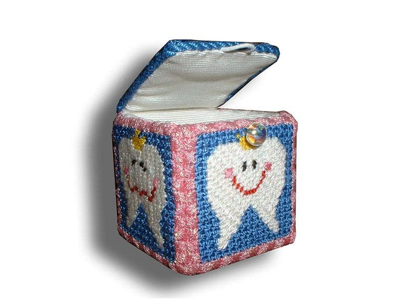 A tooth fairy box with a smiling tooth on it.