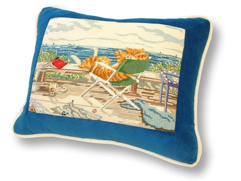 A blue pillow with an orange cat on it.