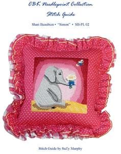 A needlepoint pillow with an elephant on it and a polka dot pattern.