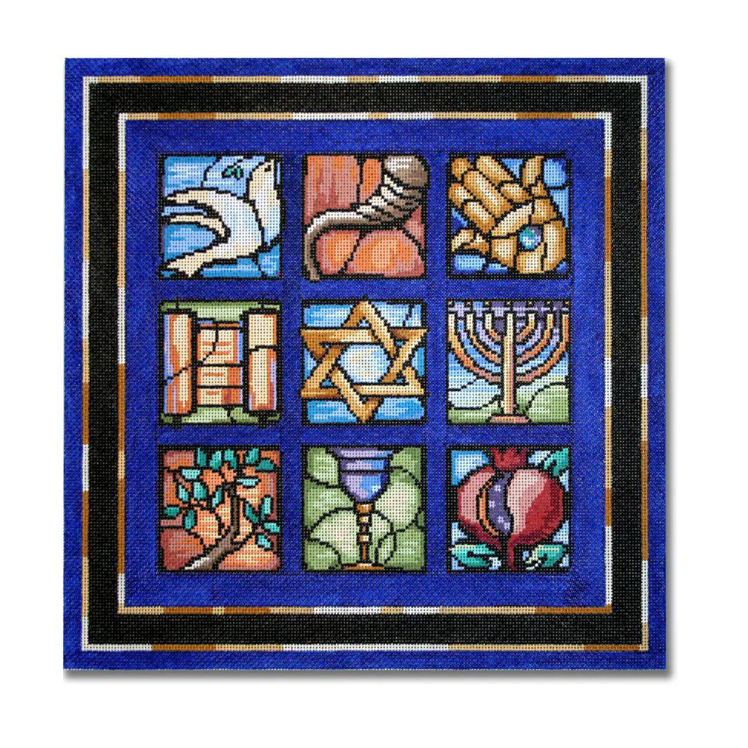 A blue stained glass panel featuring a variety of Jewish symbols, designed by Cecilia Ohm Eriksen.