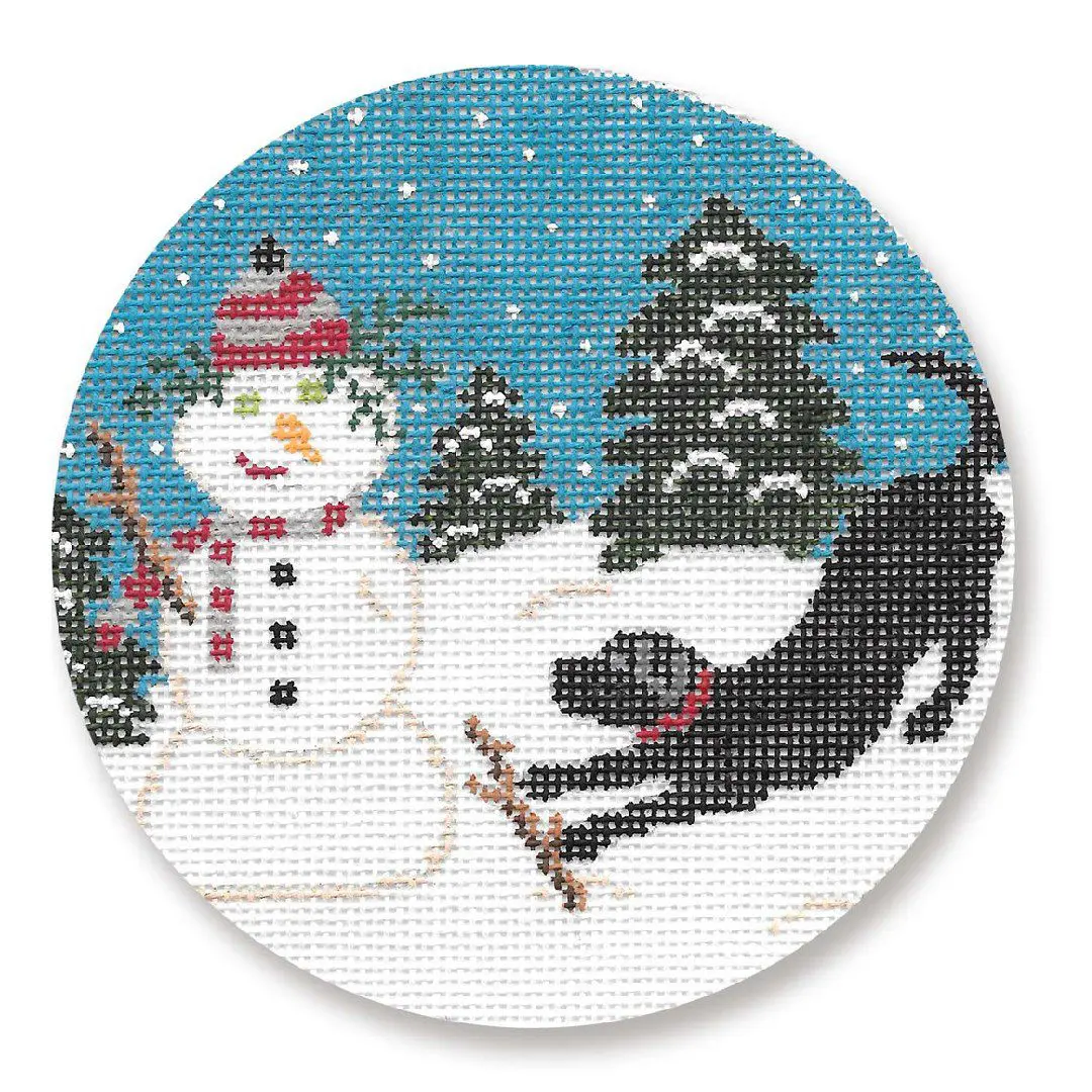 A cross stitch picture featuring a snowman and a black dog, created by Cecilia Ohm Eriksen.