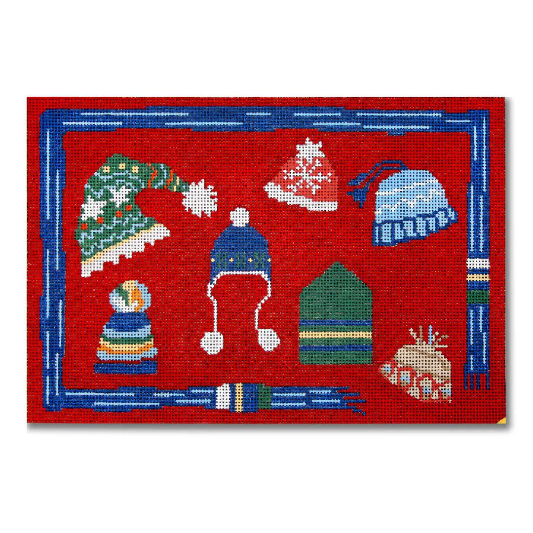 A red rug with hats and Cecilia Ohm Eriksen items on it.