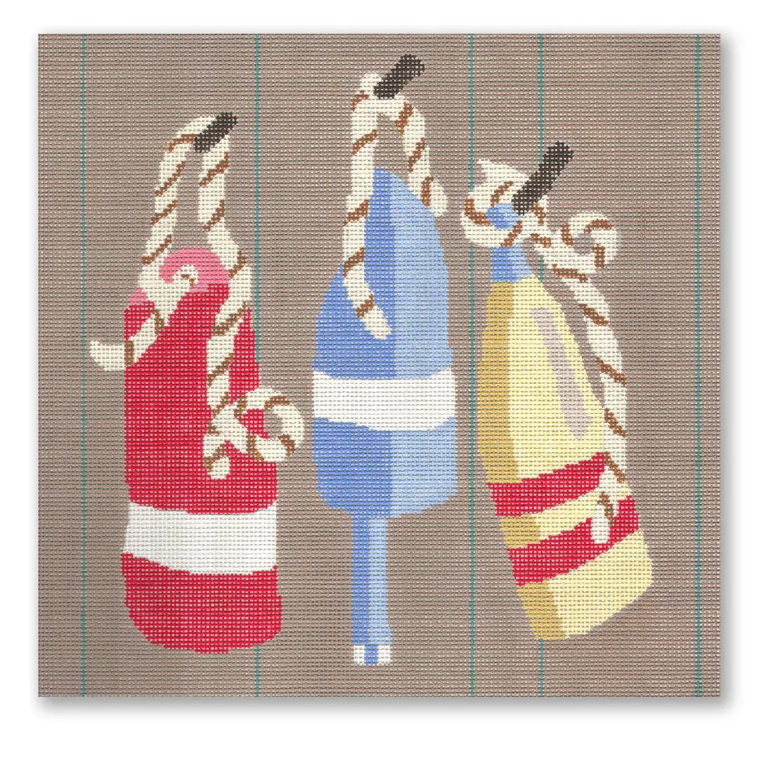 Cecilia Ohm Eriksen designed a cross stitch pattern featuring three life buoys on a brown background.