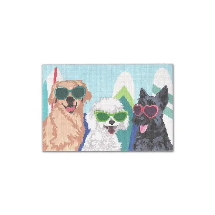 Three dogs in sunglasses on a snowy mountain, photographed by Cecilia Ohm.