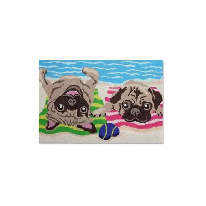 Two pug dogs, Cecilia and Eriksen, lounging on a towel on the beach.