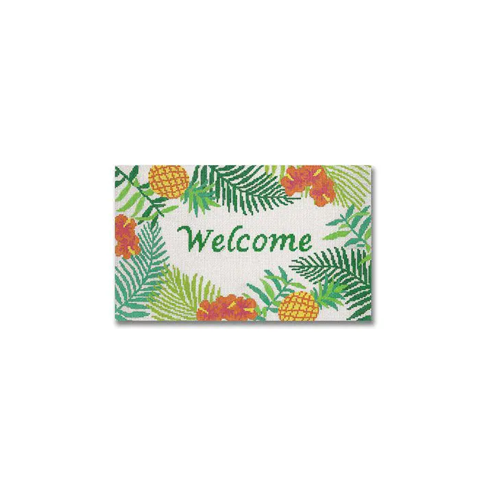 A vibrant welcome sign adorned with tropical leaves and pineapples, curated by Cecilia Ohm Eriksen.