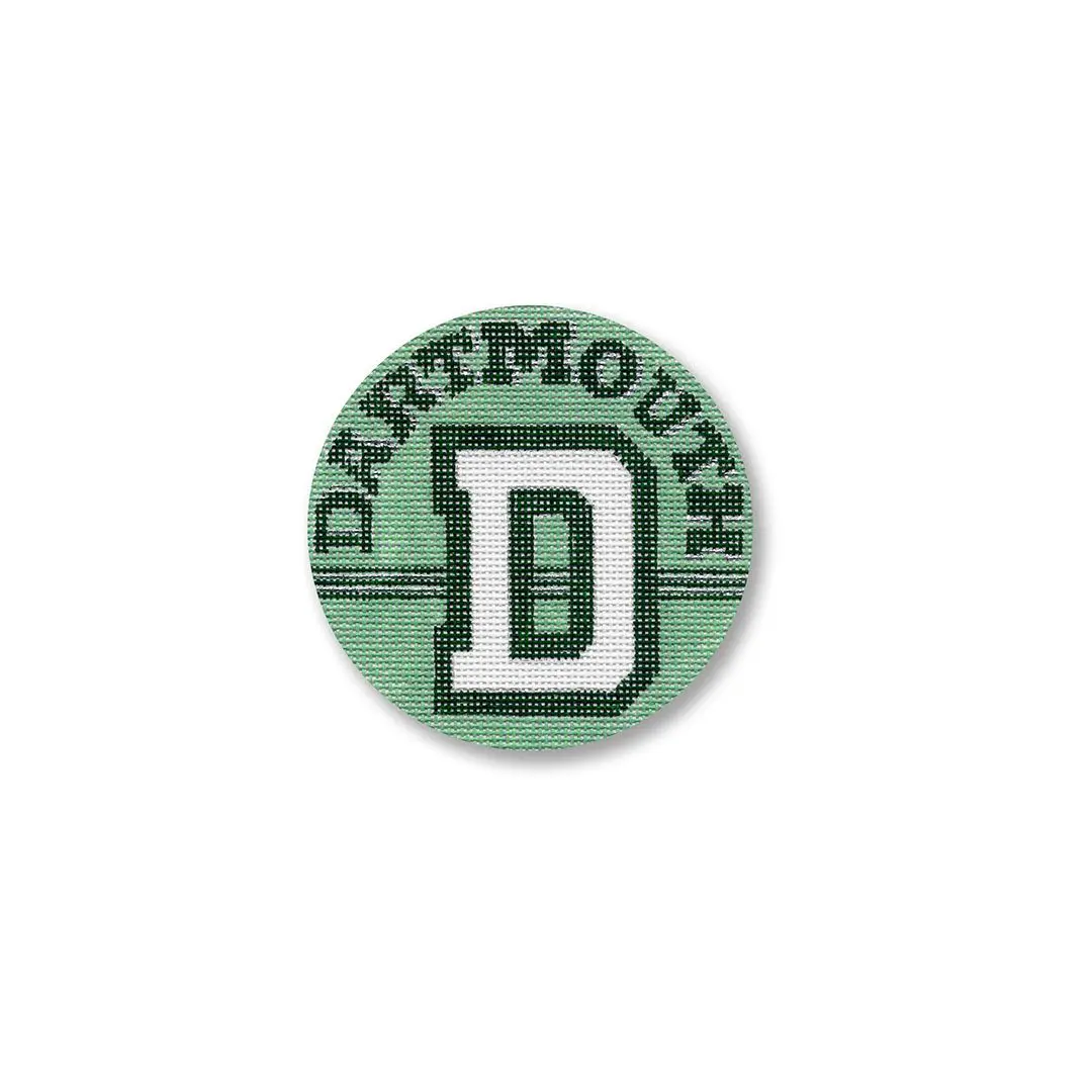 A green button with the letter d on it by Cecilia Ohm Eriksen