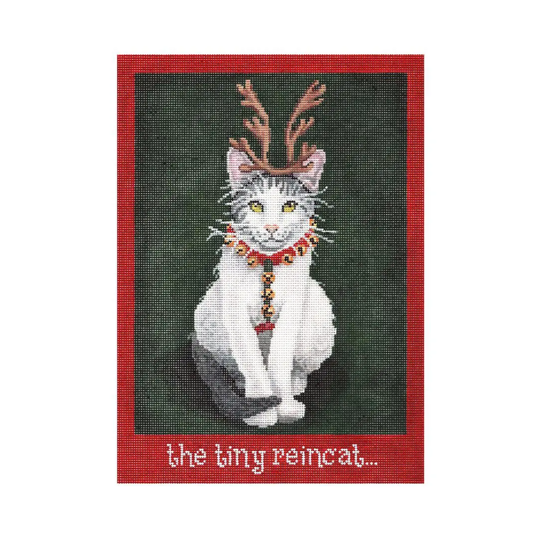 Cecilia, a cat wearing reindeer horns, poses on a red background.