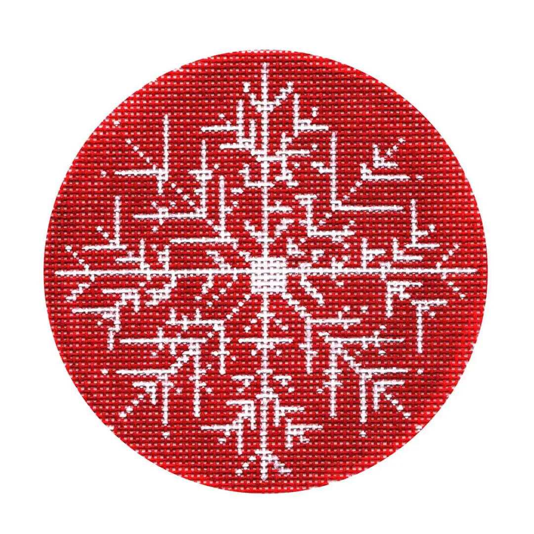 A red and white cross stitch snowflake on a circle, created by Cecilia Eriksen.