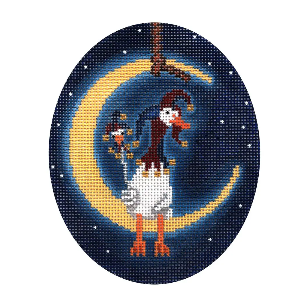 A cross stitch picture of a goose on the moon created by Cecilia Ohm Eriksen.