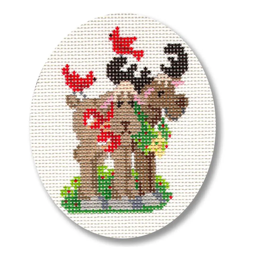 A cross stitch pattern of a moose and a bird designed by Cecilia Ohm Eriksen.