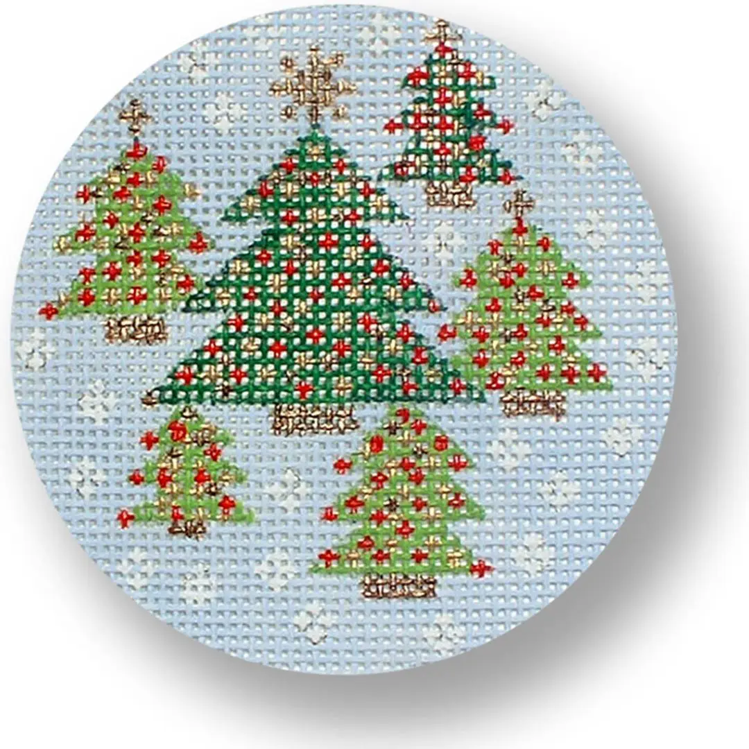 A cross stitch pattern of christmas trees on a blue background, designed by Cecilia Ohm Eriksen.