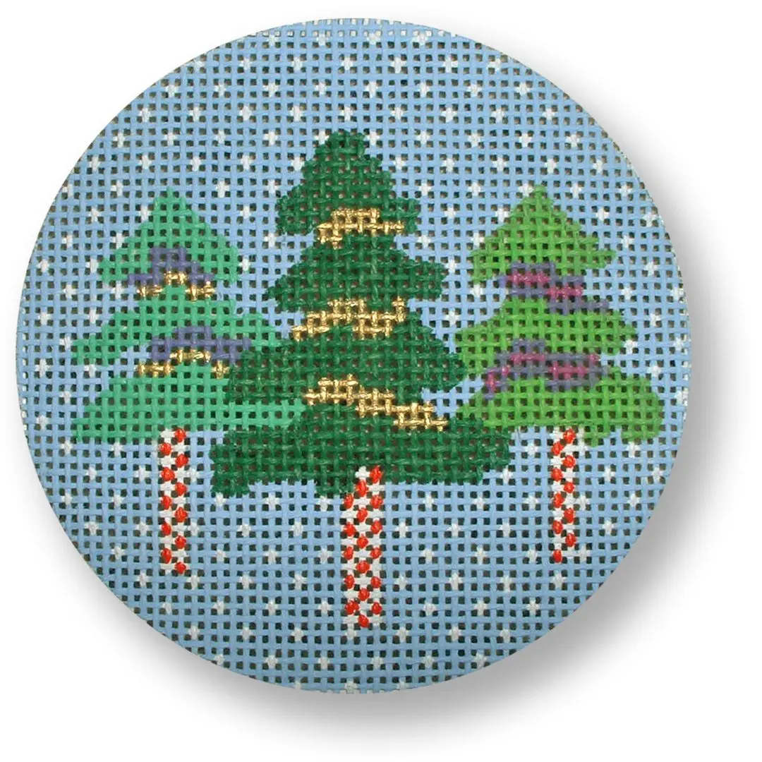 A Cecilia Ohm Eriksen cross stitch of christmas trees on a blue background.