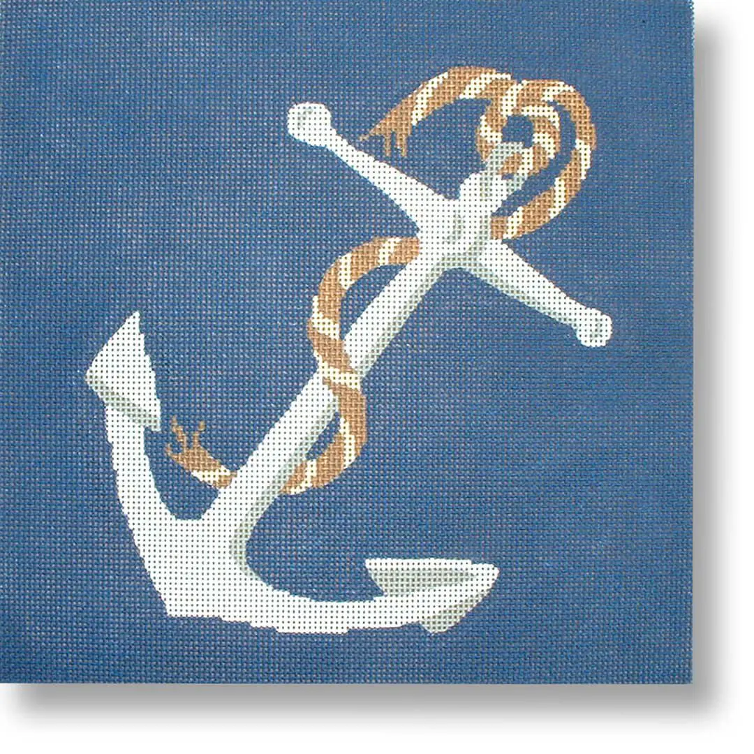 A cross stitch picture of an anchor on a blue background designed by Cecilia Ohm Eriksen.