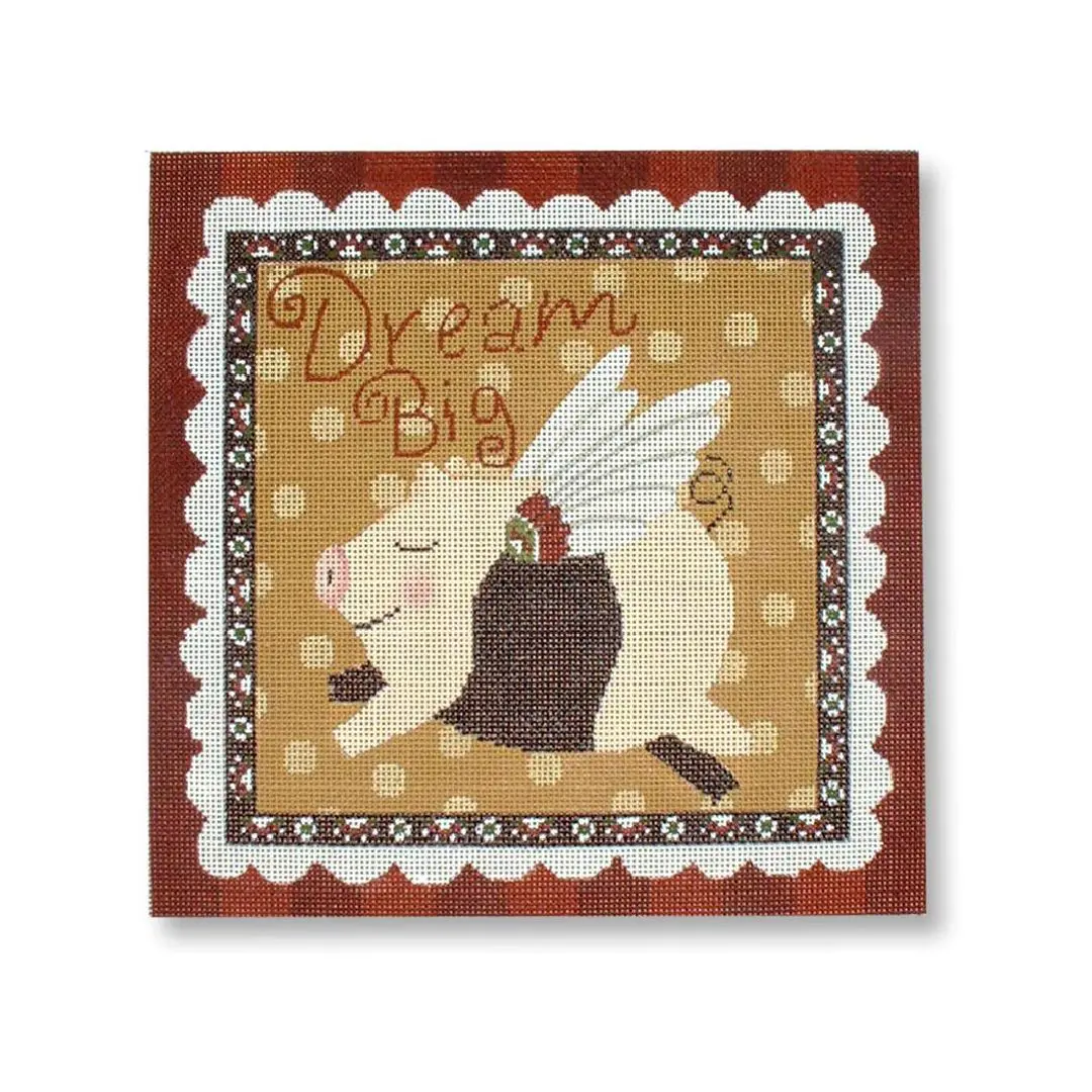 A wall hanging with the words "dream big" featuring a pig, designed by Cecilia Ohm Eriksen.