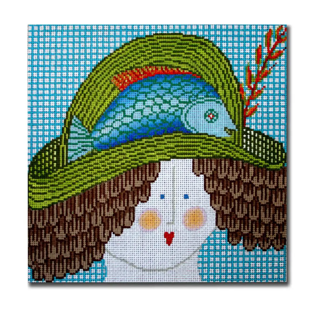 Cecilia wearing a green hat with a fish on her head.