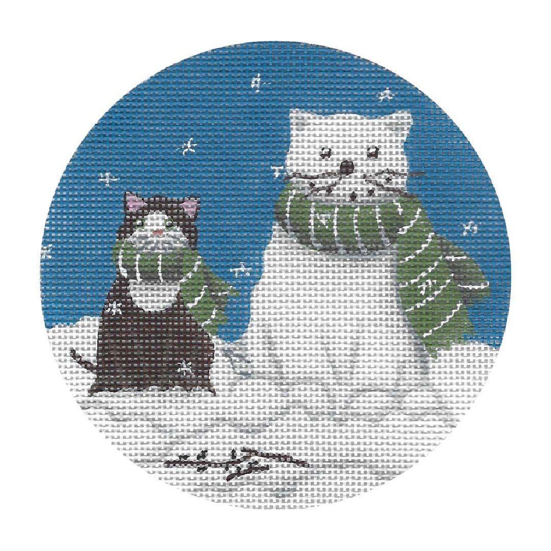 A cross stitch picture of a cat and a dog in the snow created by Cecilia Ohm Eriksen.