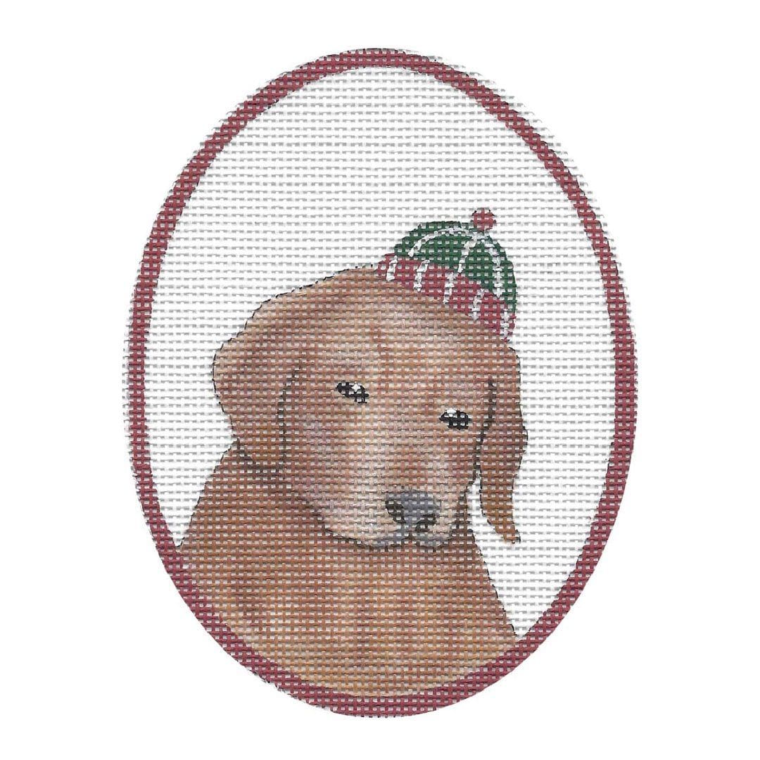 A cross stitch picture of a golden retriever wearing a hat designed by Cecilia.