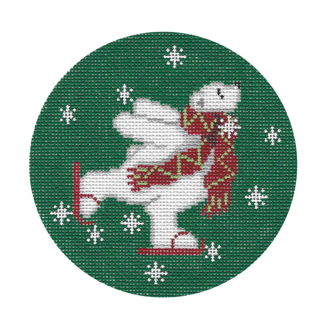 A cross stitch pattern of a polar bear on a green circle designed by Cecilia Ohm Eriksen.
