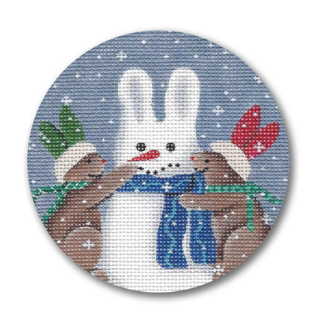 A cross stitch picture featuring two rabbits and a snowman created by Cecilia Ohm Eriksen.