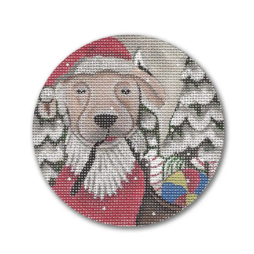 A cross stitch pattern featuring a dog with Santa Claus, designed by Cecilia Ohm Eriksen.