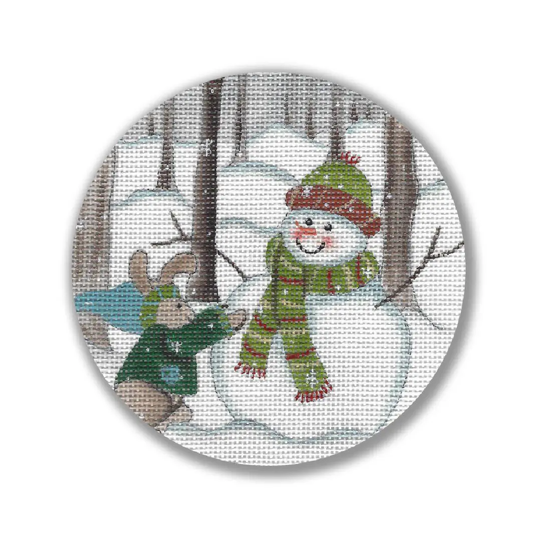 A cross stitch picture featuring a snowman and bunny in the woods, designed by Cecilia Ohm Eriksen.