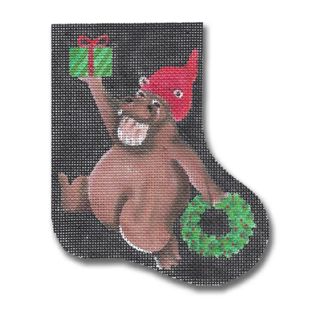 A Christmas stocking with a bear holding a wreath designed by Cecilia Ohm.