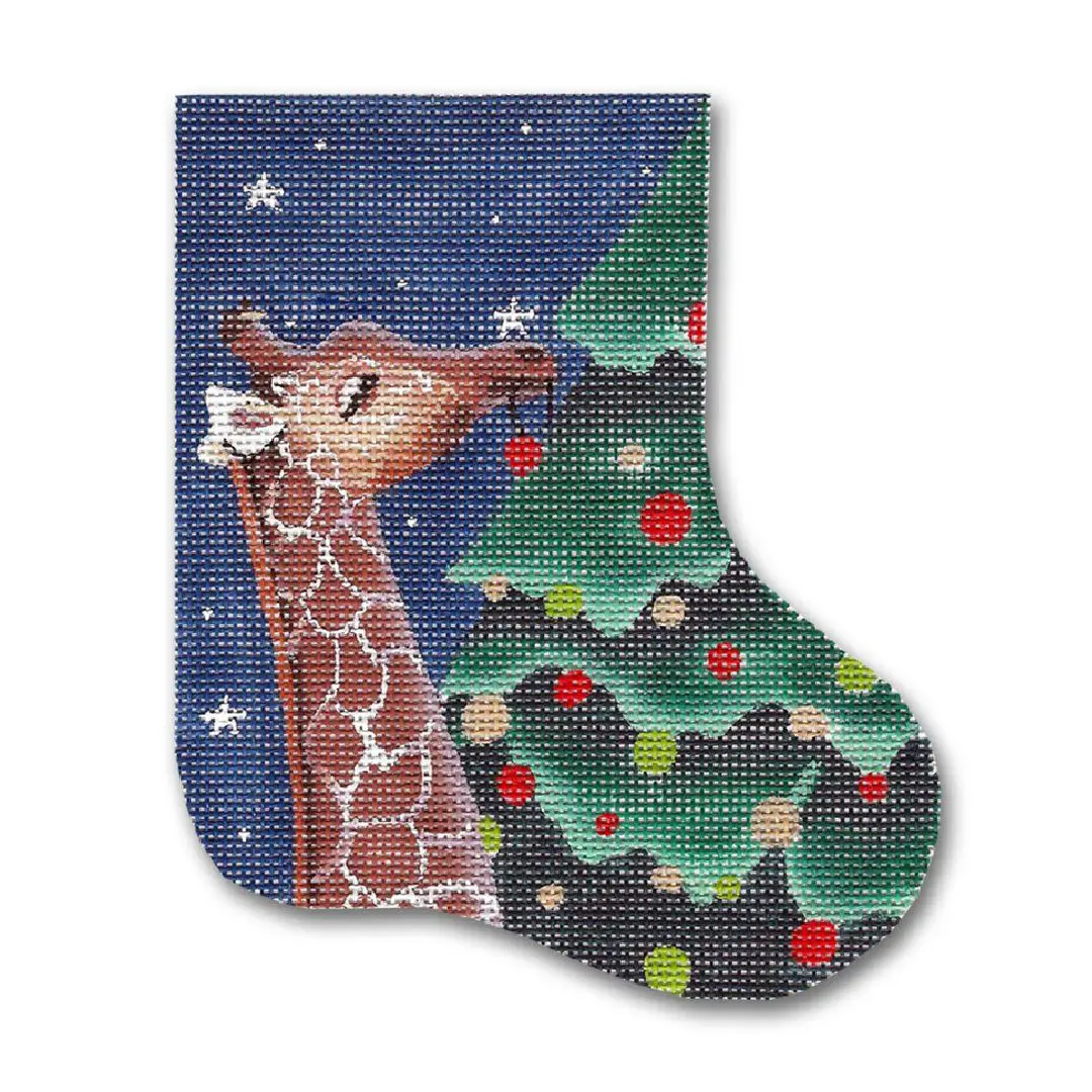 A Christmas stocking decorated with a giraffe and a Christmas tree.