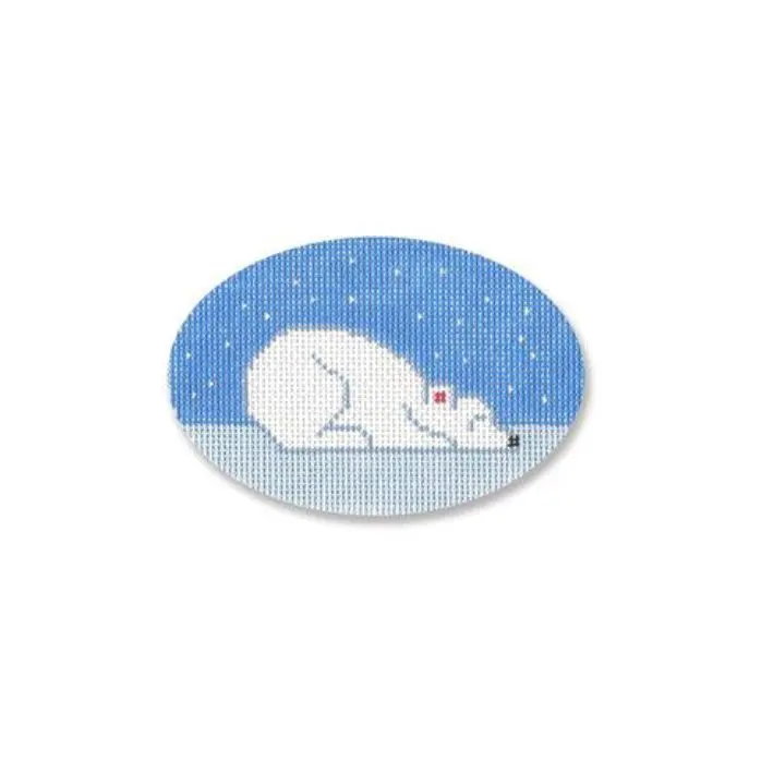 A cross stitch picture of a polar bear sleeping in the snow, created by Cecilia Ohm Eriksen.