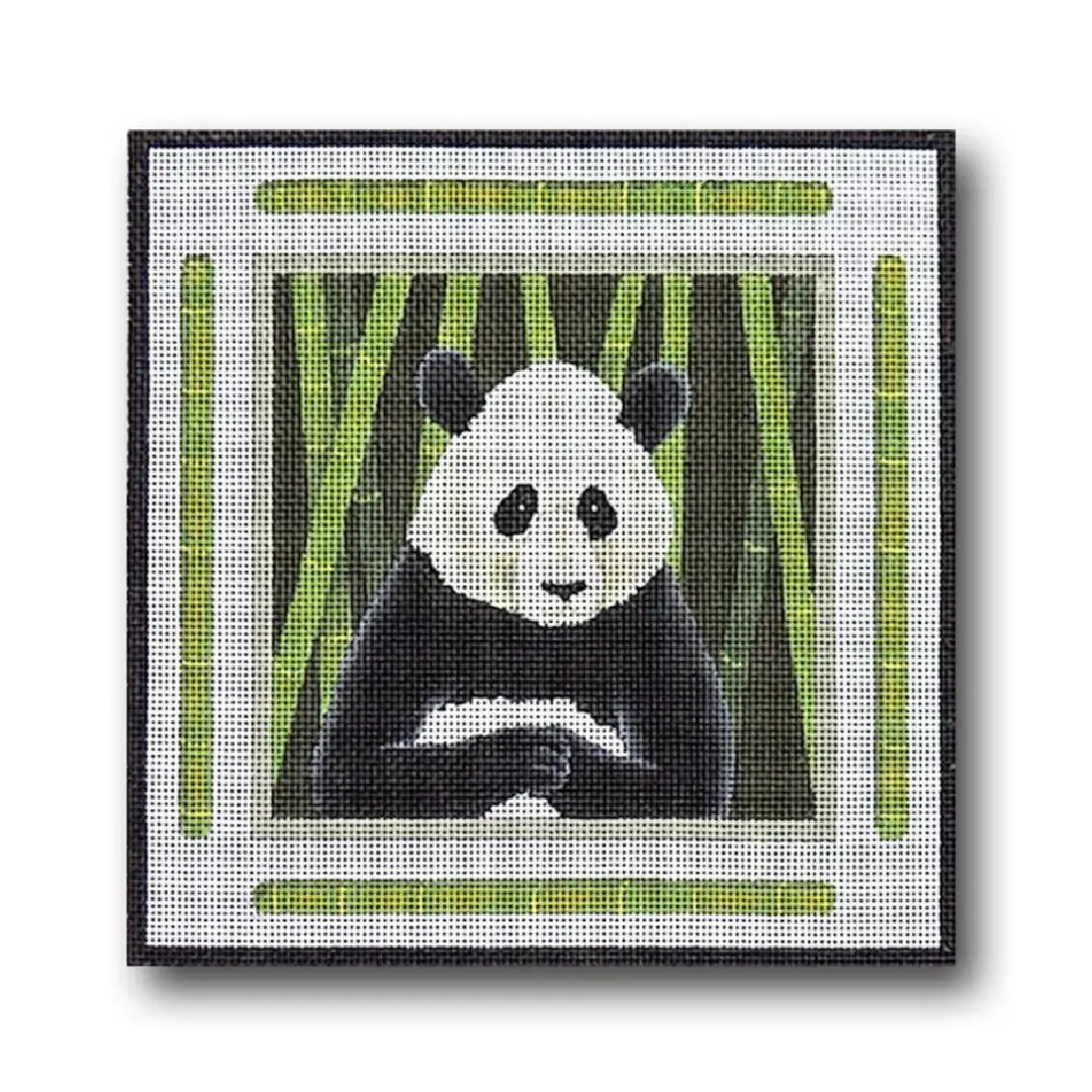 Cecilia Ohm, a panda bear, sitting in a bamboo frame.