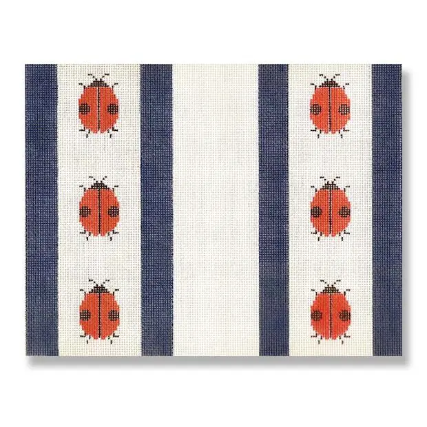 A blue and white placemat with ladybugs on it, designed by Cecilia Ohm Eriksen.