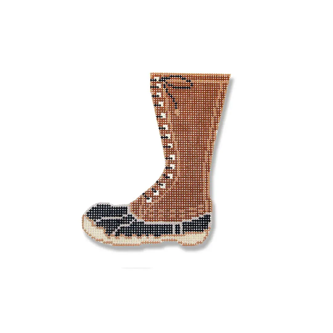 A picture of a brown and black boot on a white background by Cecilia Ohm Eriksen.