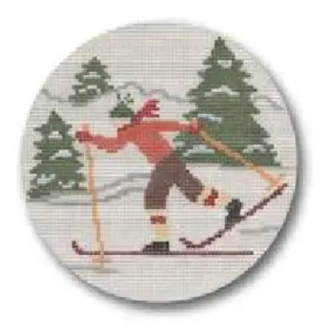 A cross stitch pattern of a skier on skis designed by Cecilia Ohm Eriksen.