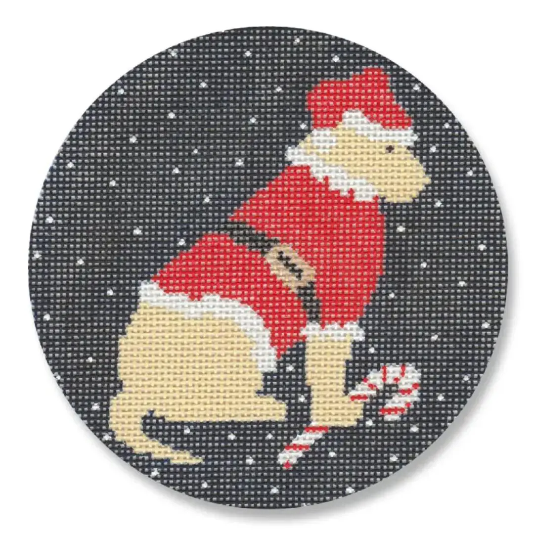 A cross stitch pattern of a santa dog with candy canes designed by Cecilia Ohm Eriksen.