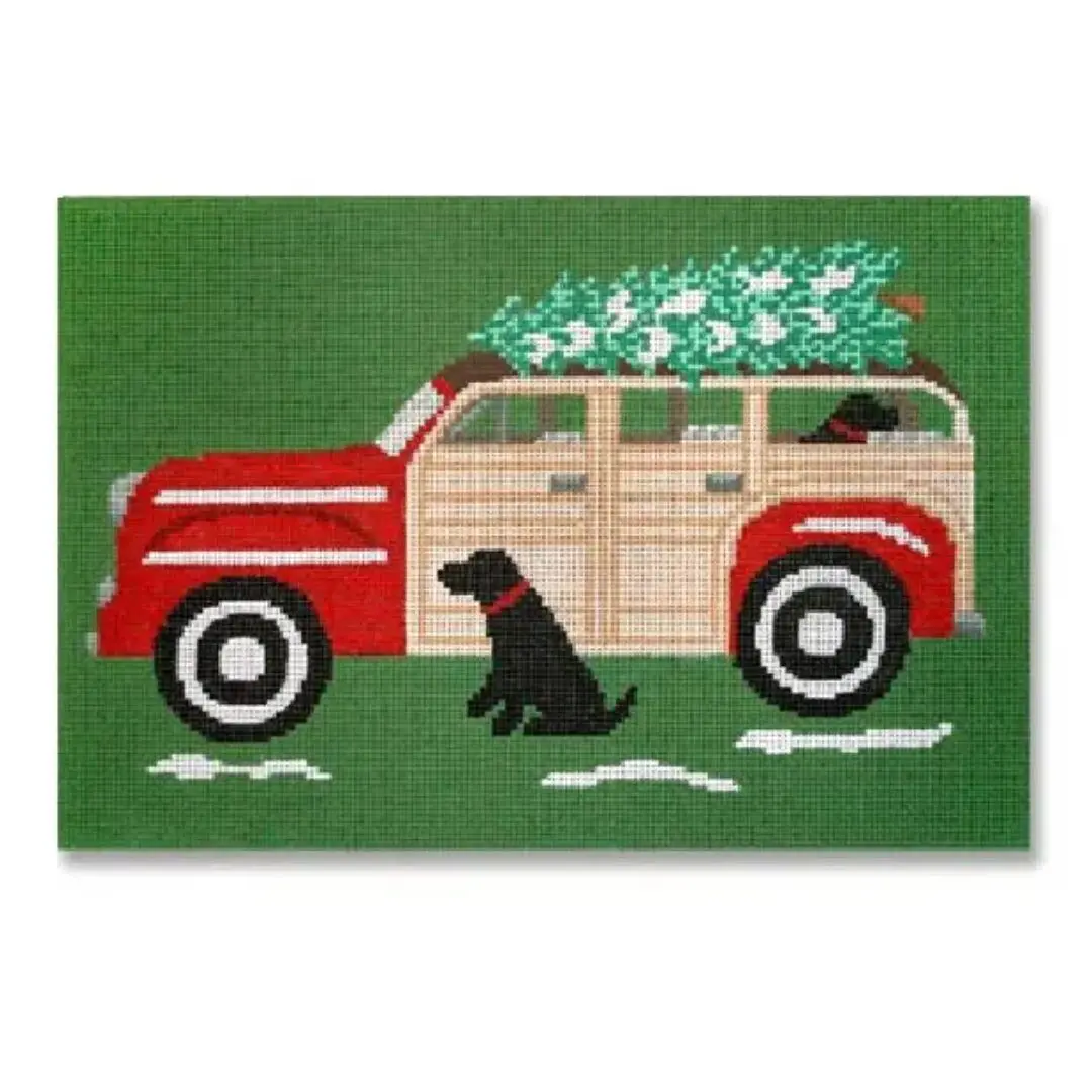 A red truck with a Christmas tree on it and a black dog owned by Cecilia.