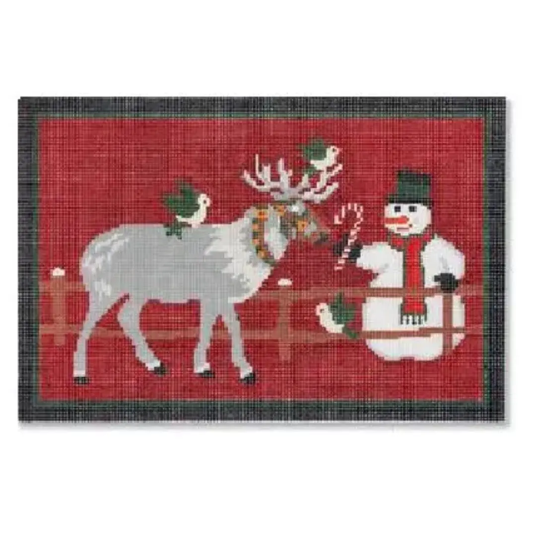 A red rug featuring a snowman and reindeer.