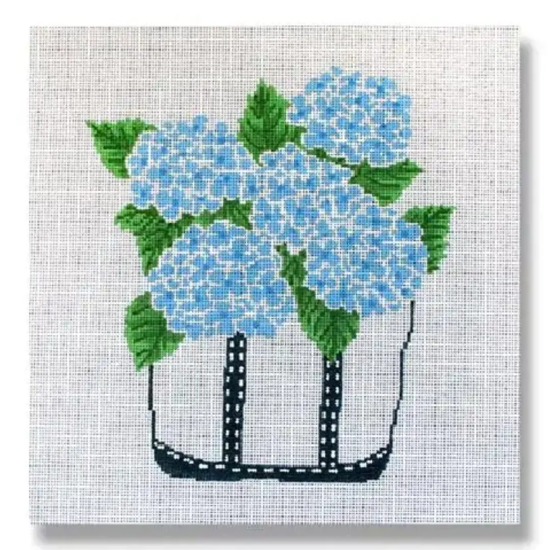 Blue hydrangeas arranged beautifully in a basket, created by Cecilia Ohm Eriksen.
