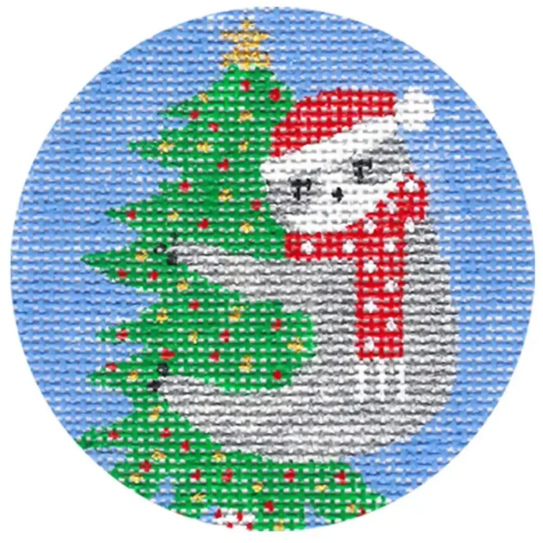 A cross stitch pattern of a sloth with a Christmas tree designed by Cecilia Ohm Eriksen.