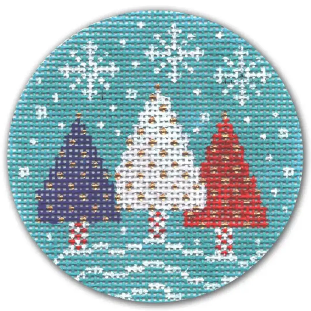 Three christmas trees cross stitched on a circle, created by Cecilia Ohm Eriksen.