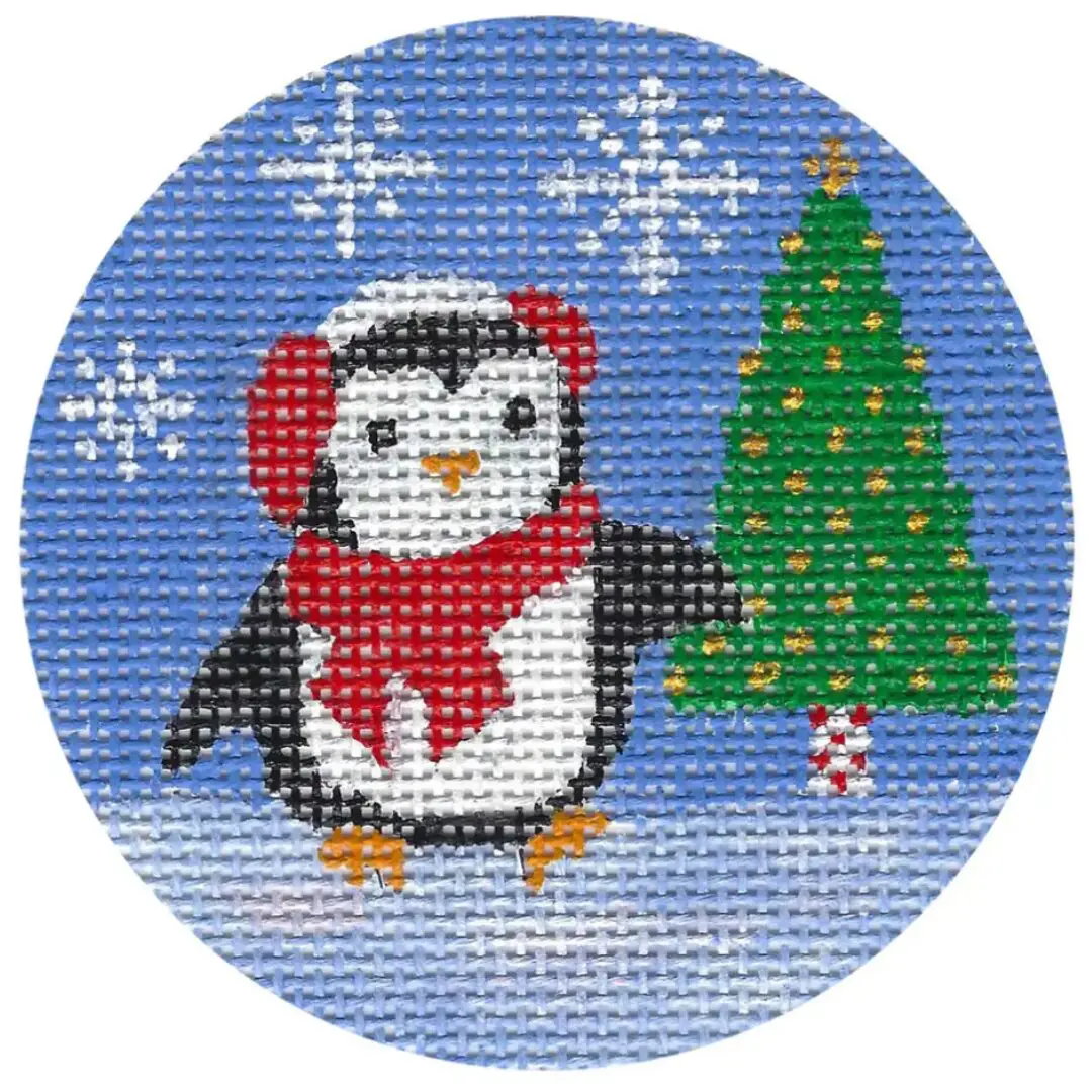 A cross stitch pattern of a penguin with a Christmas tree by Cecilia Ohm.