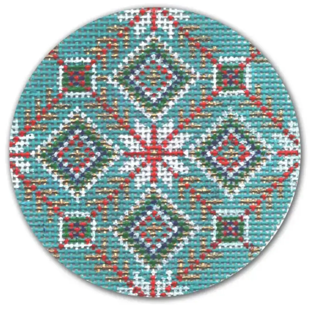 A round plate featuring a blue and red cross stitch pattern by Cecilia Eriksen.