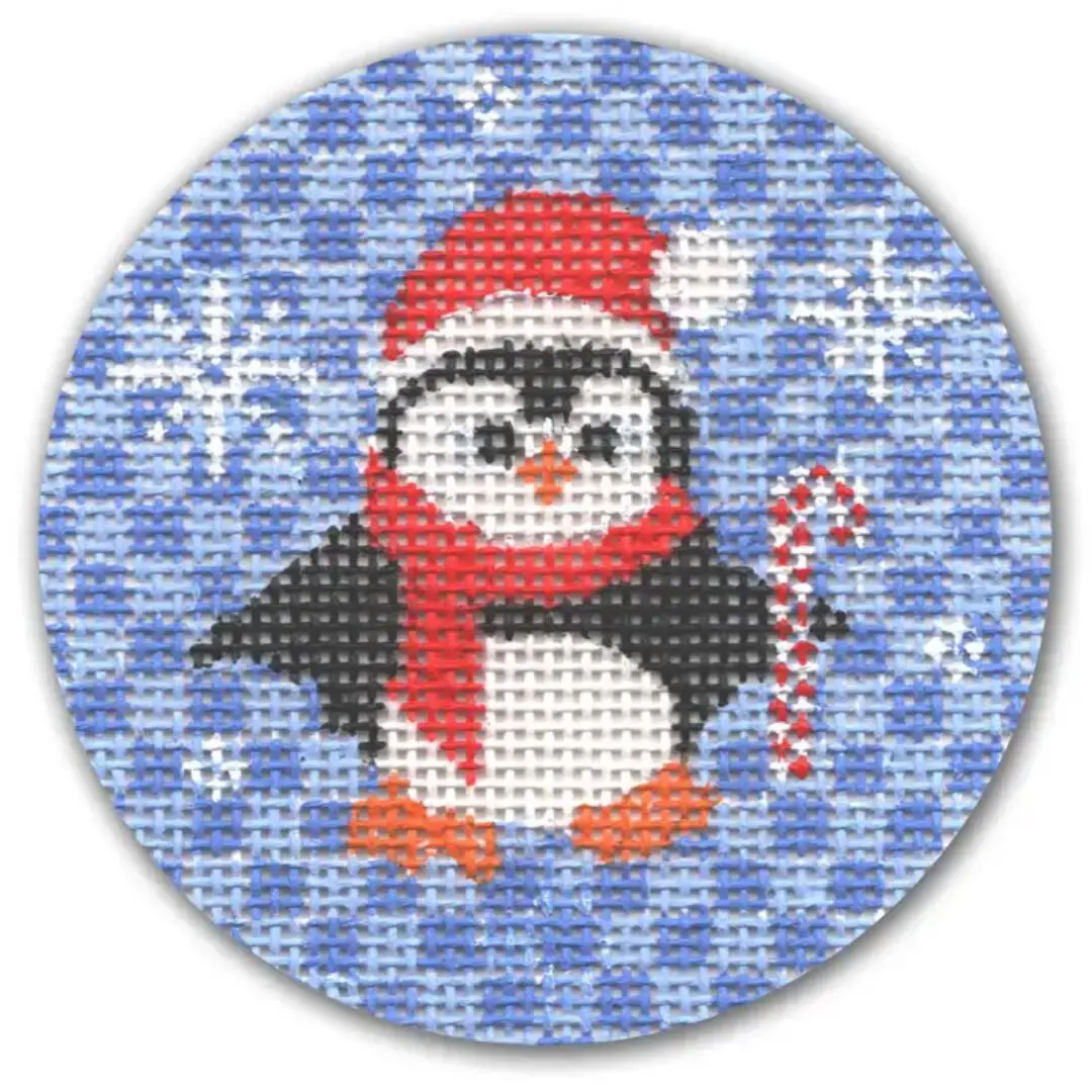 A cross stitch pattern of a penguin holding a candy cane designed by Cecilia Ohm Eriksen.