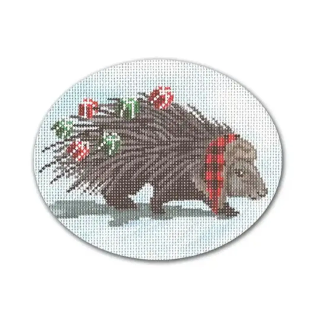 A cross stitch pattern of a porcupine with presents designed by Cecilia Ohm Eriksen.