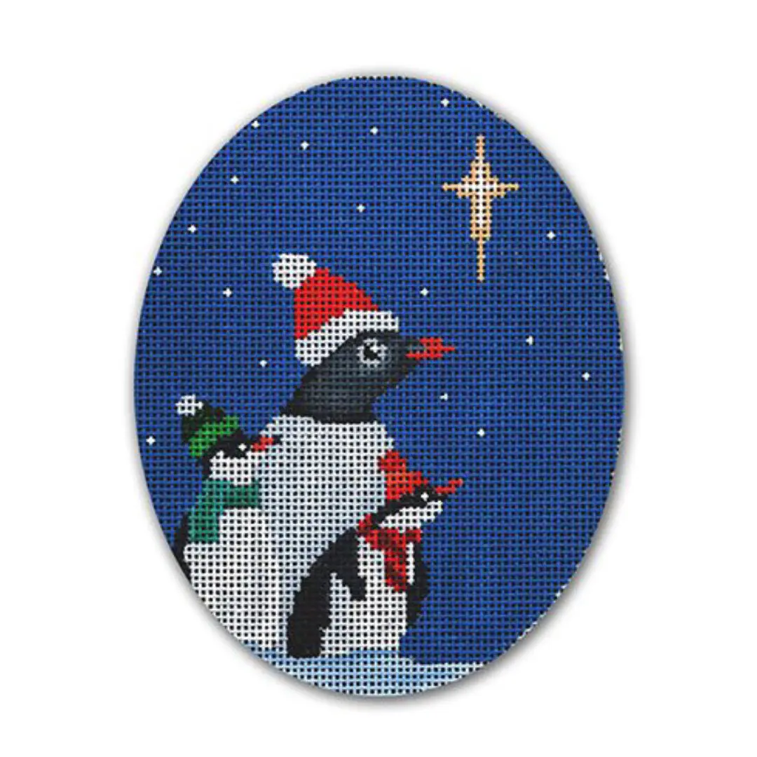A cross stitch picture of penguins and a star by Cecilia Ohm Eriksen.
