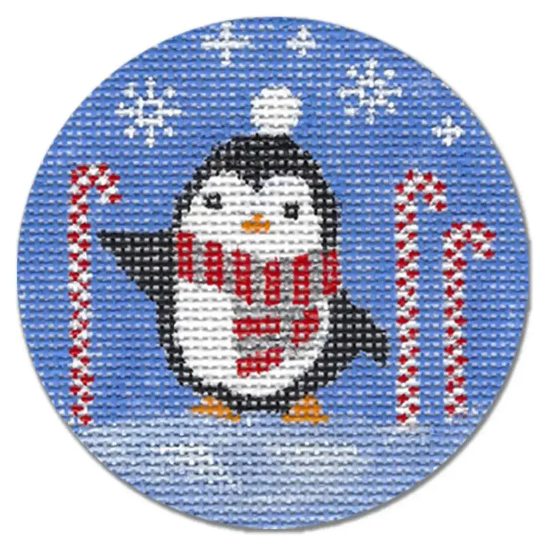 A cross stitch pattern of a penguin with candy canes designed by Cecilia Ohm Eriksen.