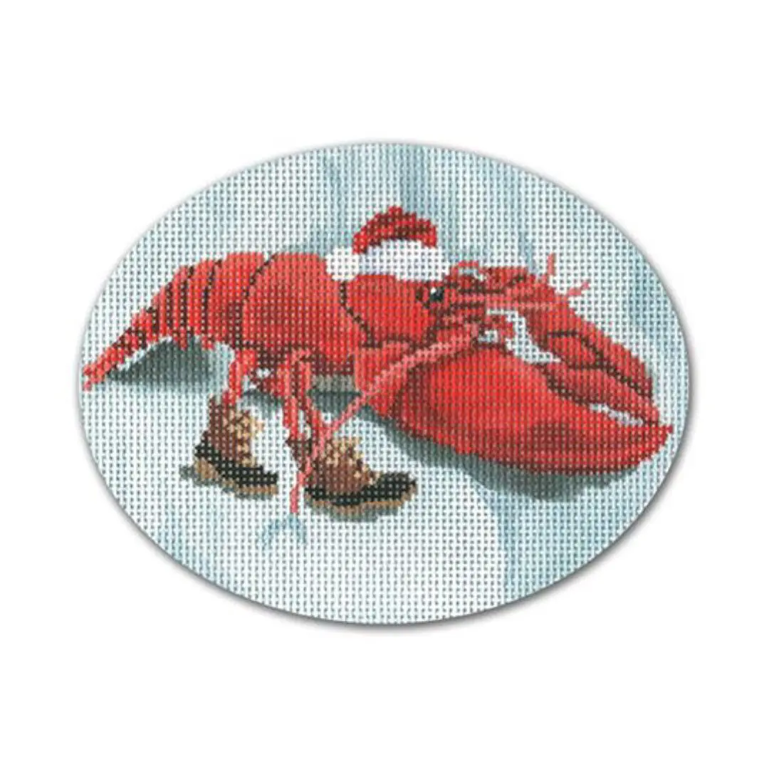 A cross stitch picture of a lobster wearing a santa hat designed by Cecilia Ohm Eriksen.