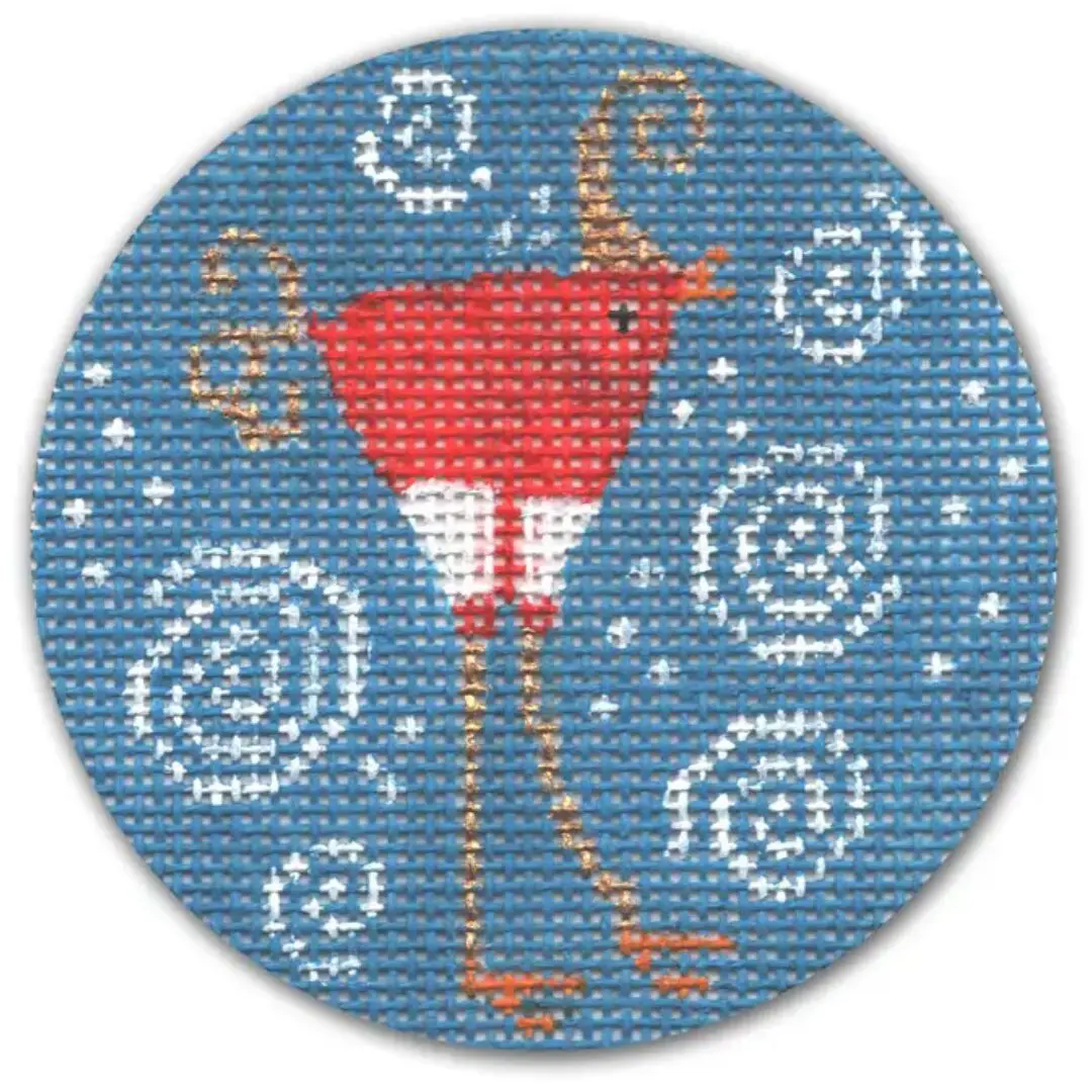 A cross stitch pattern of a red bird on a blue background designed by Cecilia Ohm Eriksen.