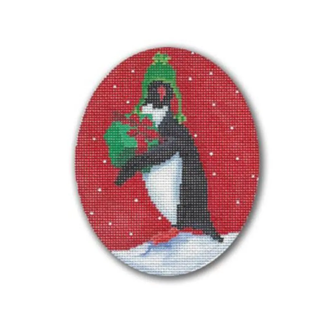 A cross stitch pattern of a penguin holding a gift by Cecilia Ohm Eriksen.