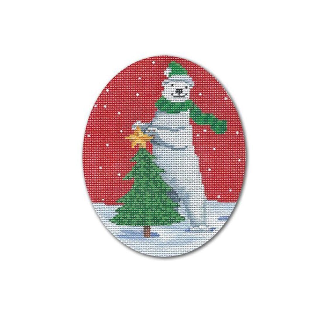 A cross stitch picture featuring a polar bear with a Christmas tree, designed by Cecilia Ohm Eriksen.
